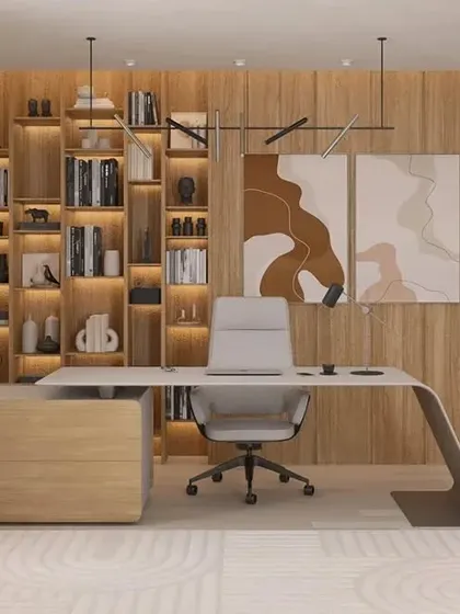 An executive office should be both functional and inspiring. We created this workspace with a custom wrap-around desk, floor-to-ceiling backlit shelving for storage and display, and a warm wood-paneled wall that exudes professionalism and style.