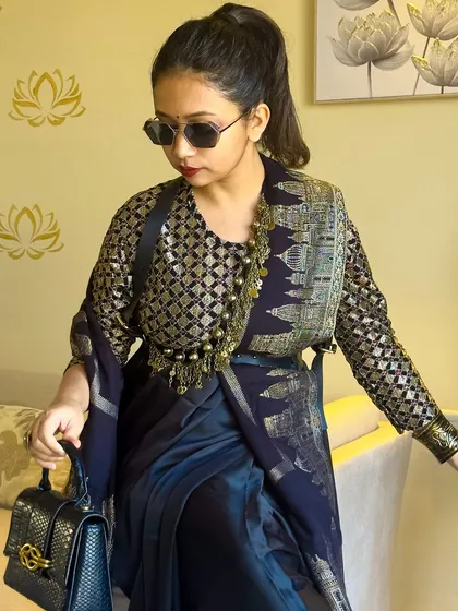 A close-up of my Sabyasachi-inspired look. The focus here is on the unconventional jewelry styling, using an Afghan necklace as a belt to cinch the waist and add a layer of texture over the saree.