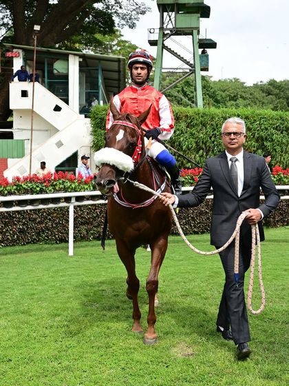 Basilica, guided by jockey P. Trevor, is led by trainer S.S. Attaollahi after winning The Champion Jockey Cup Div I.