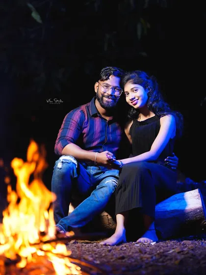 A classic portrait by the bonfire. The combination of the warm firelight and the cool blue backlight creates a visually stunning and dramatic effect.