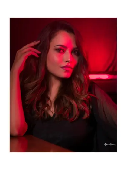 Here, I used bold red lighting in the studio to create a cinematic and moody portrait. This style is perfect for clients wanting something dramatic and eye-catching for their portfolio.