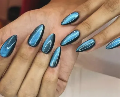 For a bold and mesmerizing look, I use a magnetic cat-eye polish. This set features a stunning blue shade on long almond-shaped nails, creating a deep, shifting shimmer that catches the light from every angle.