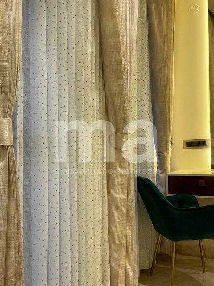 A detail of the curtain selection for the parent's bedroom. We layered warm golden-hued curtains with off-white sheers featuring delicate dotted thread work, adding texture and elegance.