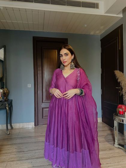 The full look of this stunning purple Anarkali by Charu Makkar. The tiered design at the bottom adds a modern touch to a classic style.