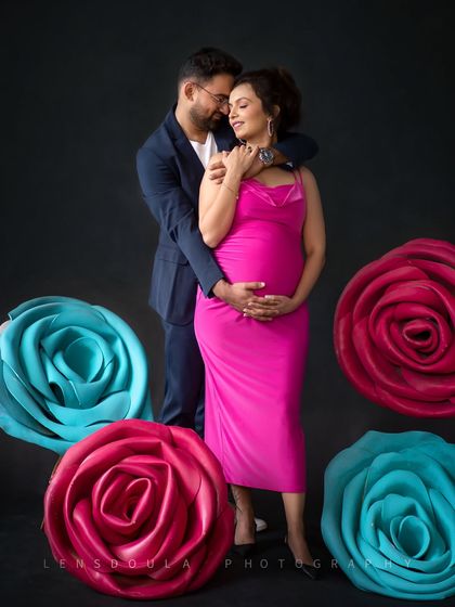 An embrace that says everything. The dark background makes the couple's connection and the bright colors of the props pop.