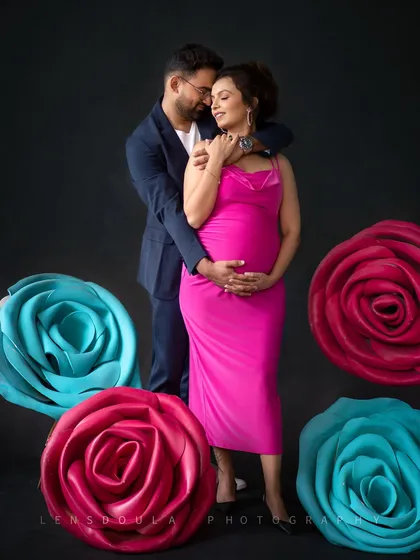 An embrace that says everything. The dark background makes the couple's connection and the bright colors of the props pop.