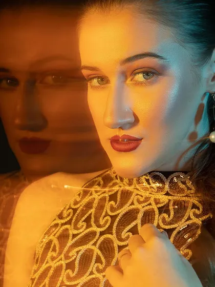 Here I combined a slow shutter speed with colored gels to create this ghosting effect. It gives the portrait a surreal and futuristic feel, perfect for a creative portfolio.