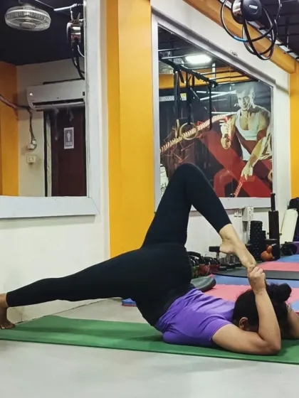 This advanced supine stretch, Eka Pada Supta Virasana variation, requires deep hip and quadriceps flexibility.