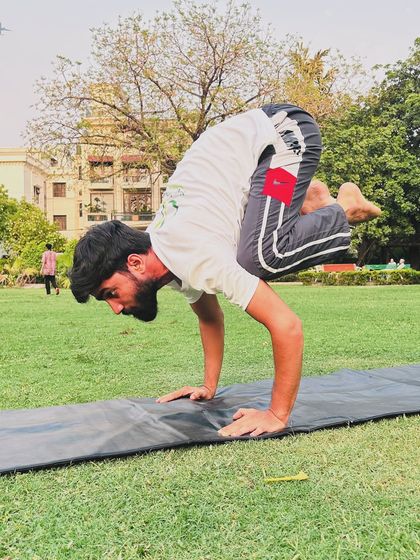 The crow pose, or Bakasana, is a foundational arm balance that builds upper body strength and focus.