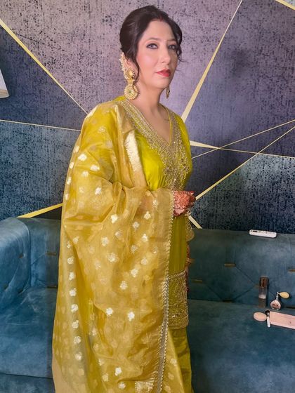 A poised and elegant guest, ready for the wedding festivities. The makeup is classic and radiant.