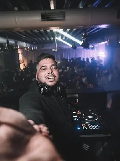 Reaching out to the crowd, breaking the barrier between the DJ and the dancefloor.