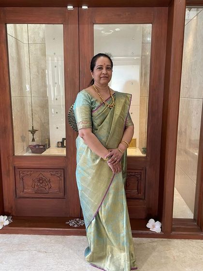 Another elegant portrait of Keerthana, her pastel saree a picture of sophistication.