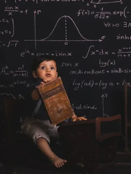 A future genius at work. Our chalkboard theme with mathematical formulas is a fun and quirky idea for a photoshoot.