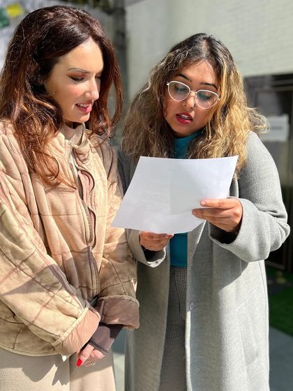 Two writers discussing their work during a break at the fiction workshop. These informal moments of peer feedback and collaboration are a crucial part of the learning experience.