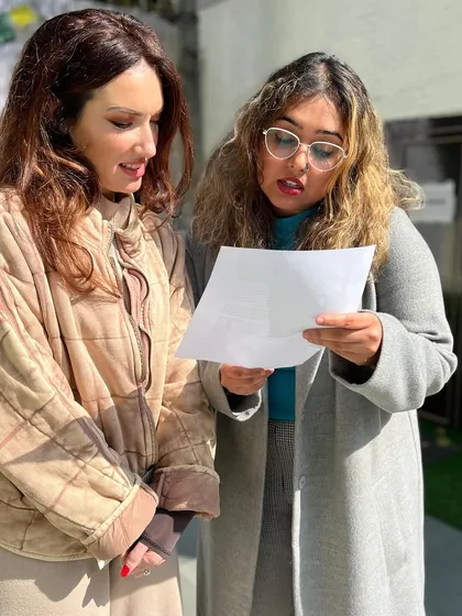 Two writers discussing their work during a break at the fiction workshop. These informal moments of peer feedback and collaboration are a crucial part of the learning experience.