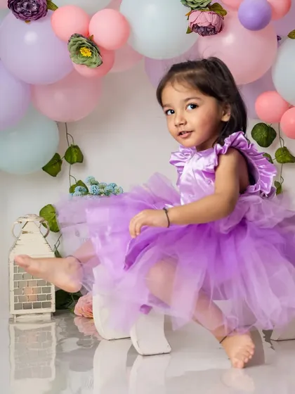 Kicking back and relaxing. This two-year-old shows off her fun personality during her pastel-themed birthday celebration.