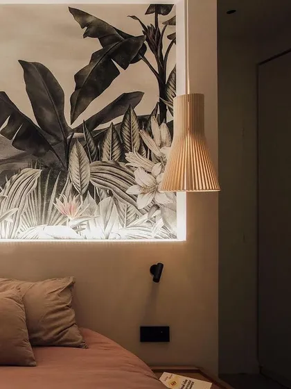 The classic Secto Design pendant used as a bedside light. Its warm, downward-focused light is perfect for reading, and its sculptural form adds a touch of design sophistication.