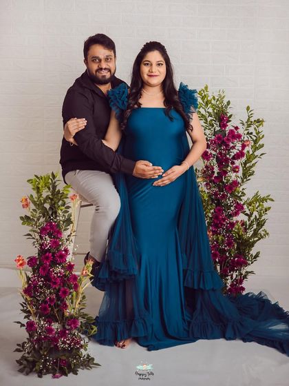 A lovely portrait of the couple surrounded by flowers. Her gorgeous teal gown with ruffled sleeves adds a wonderful pop of color and texture.