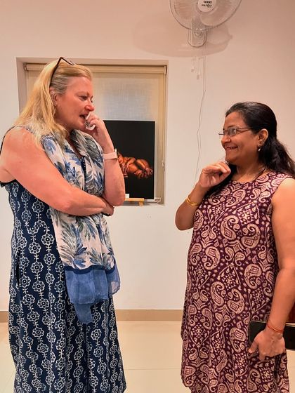 Two attendees engage in a thoughtful conversation after a book reading and discussion event at our studio.