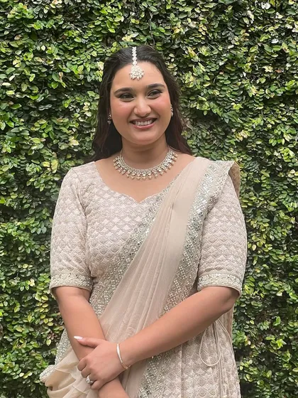 A smiling shot of the mehendi bride, her makeup looking fresh and radiant.