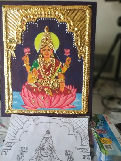 A finished Lakshmi Tanjore painting, available for sale. This piece shows the goddess of wealth seated on a lotus, framed by an ornate arch.