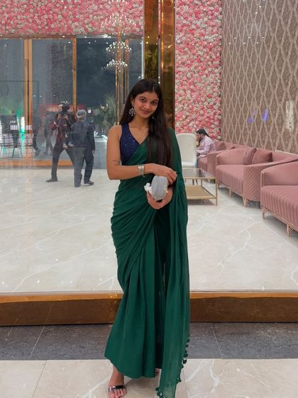A full-length shot of my green saree look for a wedding event, showing how I dress for the occasion.
