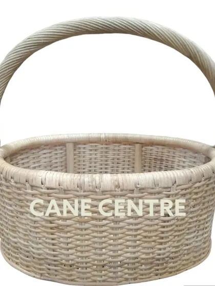 A classic, all-purpose round basket made from natural, light-colored cane. Its simple, tight weave and strong handle make it a durable choice for carrying items or for home display.