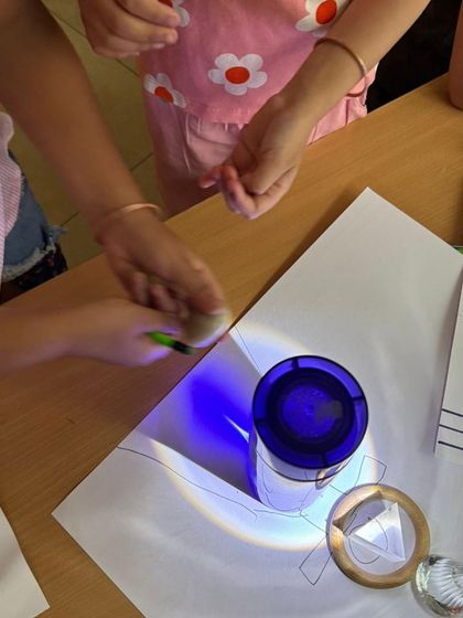 In our emergent literacy workshop, children explore light and shadow. By tracing the shadows of objects, they develop fine motor control and visual thinking, turning a science concept into a pre-writing and storytelling activity.