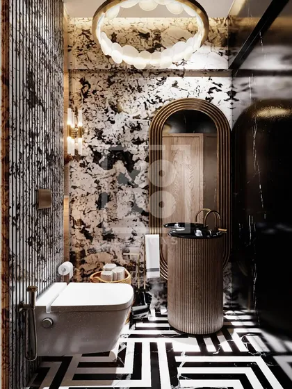 Bold and artistic, this powder room features striking black-and-white patterned marble and geometric floor tiles. The unique light fixture and fluted pedestal sink make it a memorable design statement.