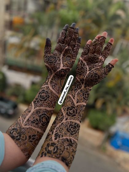 A beautiful outdoor shot of the designer mehendi. The natural light highlights the intricate details and the unique flow of the pattern.