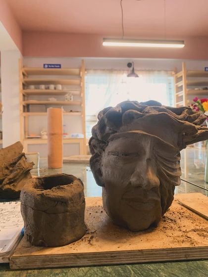 Another piece from Day 1 of the sculpture workshop, a powerful face with a blindfold, emerging from the clay.