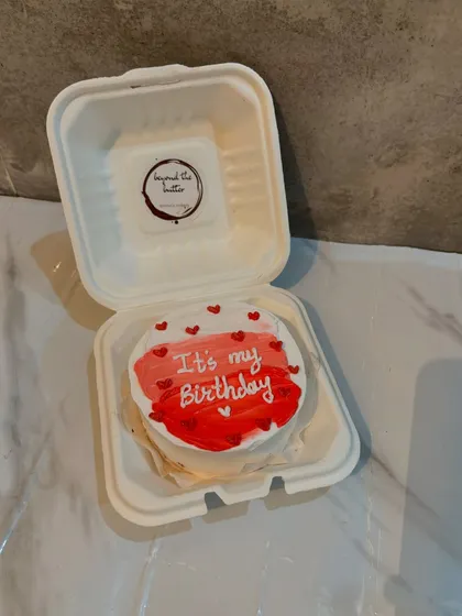 A personal bento cake for celebrating your own birthday. This one has a fun, painted red and white design and says "It's my Birthday."