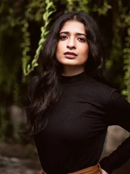 A smart and elegant portrait where the makeup is clean and sophisticated. A defined brow, soft contour, and a deep nude lip create a polished and professional look.