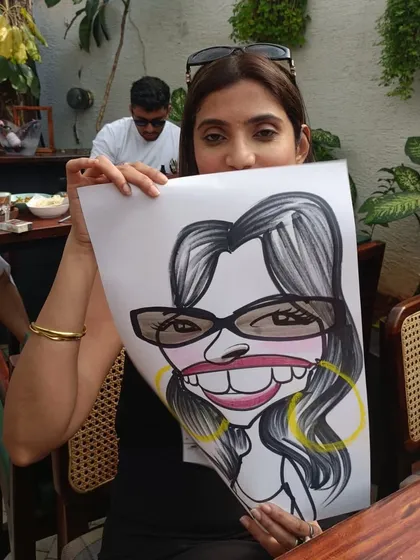 This guest is hiding behind her caricature, a fun pose I see a lot.