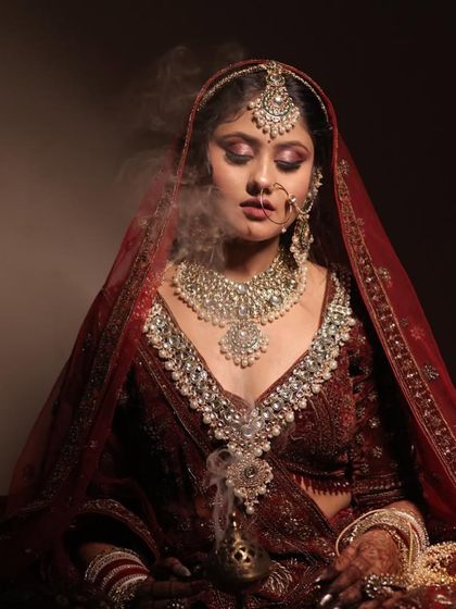 A creative and moody shot that adds a touch of drama. The makeup still looks flawless and powerful even in such artistic lighting.