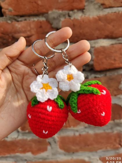Sweet strawberry and daisy keychains. These come in red, pink, and purple, each with a little white flower.