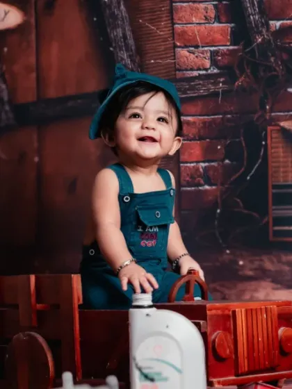 Just a little engineer in training, exploring his workshop full of toy trucks and tools.