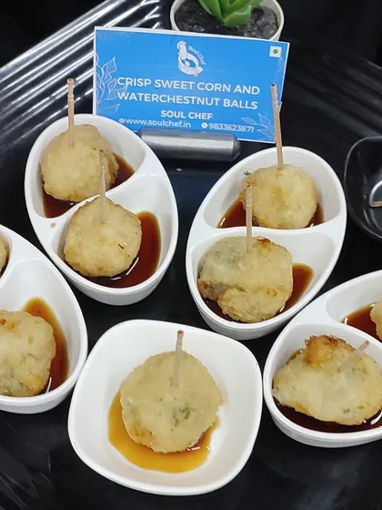 Crisp Sweet Corn and Waterchestnut Balls served with a dipping sauce, a delightful vegetarian starter with an Asian twist.