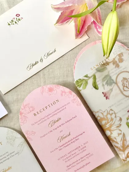 This design shows the beauty of combining different materials and shapes. I used a delicate floral vellum sleeve over an arched, blush pink reception card with gold foil text to create a soft, romantic, and layered effect.