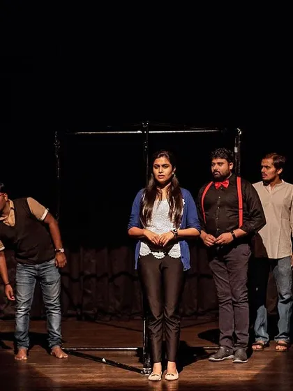 We use every element of the stage to tell a story. This powerful shot from our play "E=Mc2" showcases our approach to minimalist set design and dramatic lighting to explore complex themes like schizophrenia.