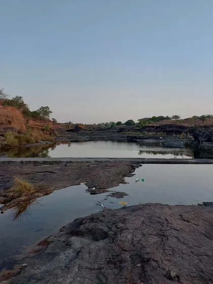 A quiet, rocky stream at dusk. These are the places we seek out for quiet reflection. The stillness of the water and the vastness of the landscape help to quiet the mind.