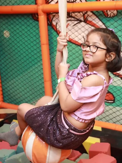 It's not just about slides and ball pits. I offer unique activities like this foam pit with a swing, where kids can safely challenge themselves and have a blast. It’s one of the many attractions in my diverse indoor play area.