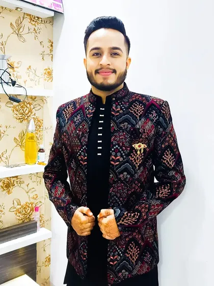 A posed shot of the groom in his Sangeet attire. The detailed jacket and clean grooming create a memorable and stylish look.