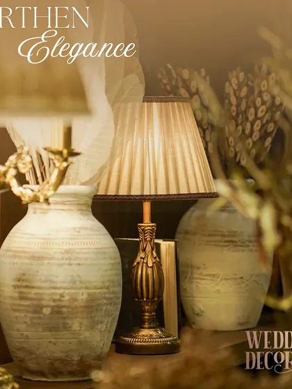 The 'Earthen Elegance' theme is all about texture and warmth. This vignette shows how I layer rustic vases, dried botanicals, and classic table lamps to create a sophisticated, home-like feel.