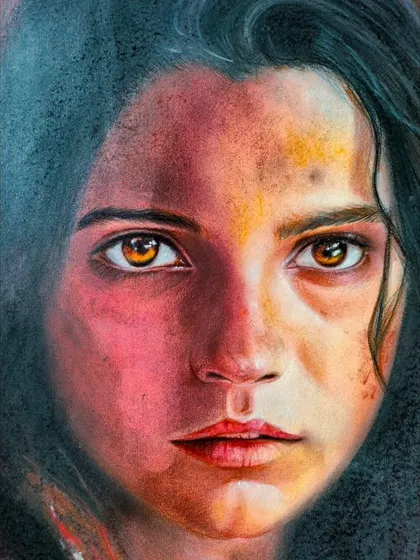 A close-up of the soft pastel portrait, showing the rich texture and blending of colors used to create a realistic and emotive expression.