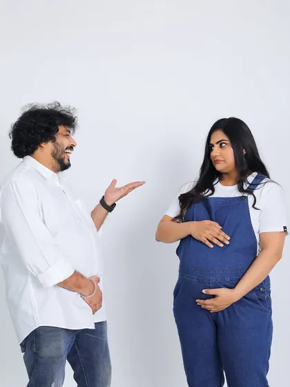 Maternity shoots can be fun and playful too. This casual studio session captures the happy and lighthearted side of a couple's pregnancy journey.
