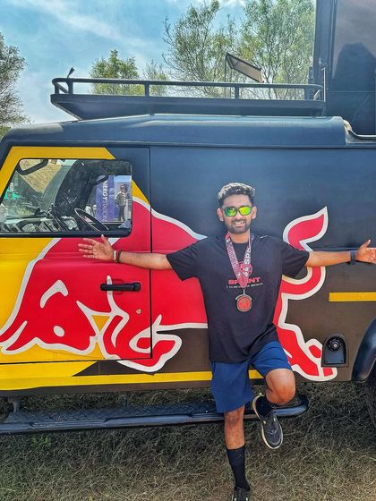 The fun doesn't stop at the finish line. Posing with the iconic Red Bull truck after a grueling Spartan Race. It's all part of the awesome event day experience.