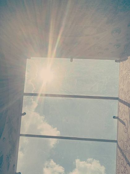 The sun's rays beaming through the skylight and hitting the top of the installation. This captures the dynamic quality of the project, where natural light becomes an active element of the artwork itself.