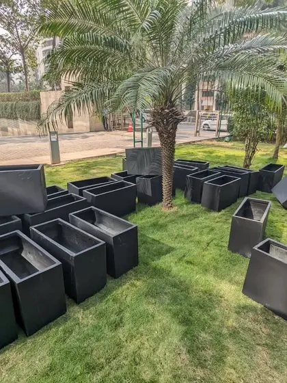 A team member carefully unboxes the planters on site. We take great care during every step, from transportation to unboxing, to ensure the planters are in perfect condition.