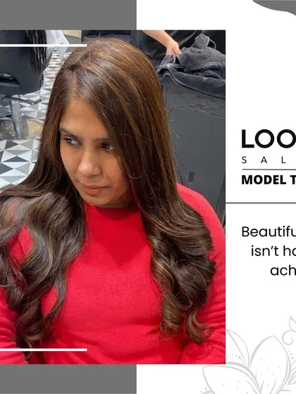 A client looking pleased with her subtle and natural-looking hair color. The soft highlights add dimension without being overpowering.